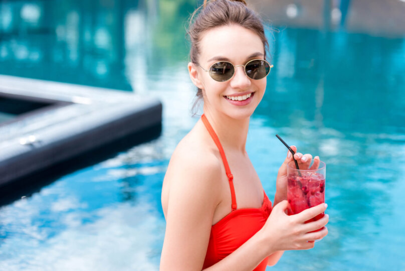 woman wearing Natural Red Color swimsuit and juice